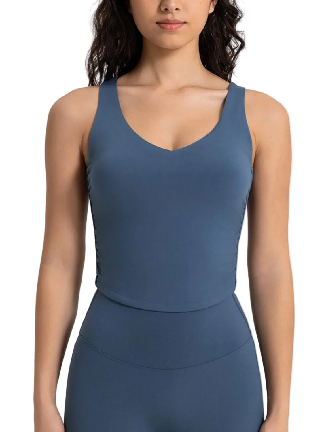 Women's cropped V-neck sport tank tailored to pair with high-waisted leggings for yoga